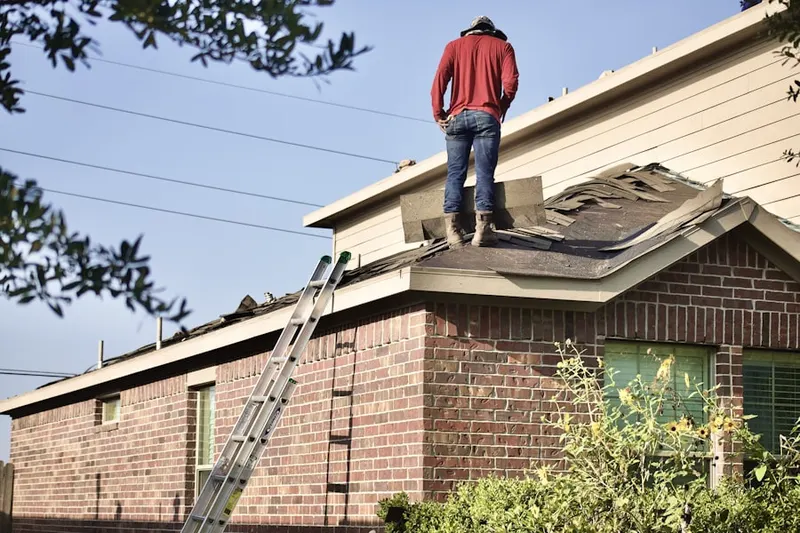 Professional roofer working on a residential roof in Mount Auburn